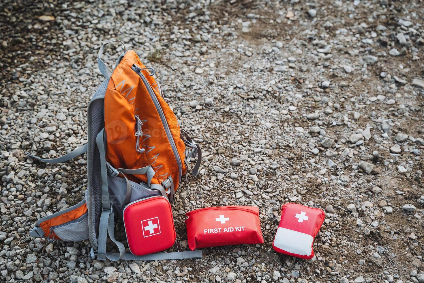 Essential Outdoor Adventure Gear Includes First Aid Kits Alongside a Sturdy Backpack, Ideal for Your Journey on Gravel Paths and Nature Trails photo