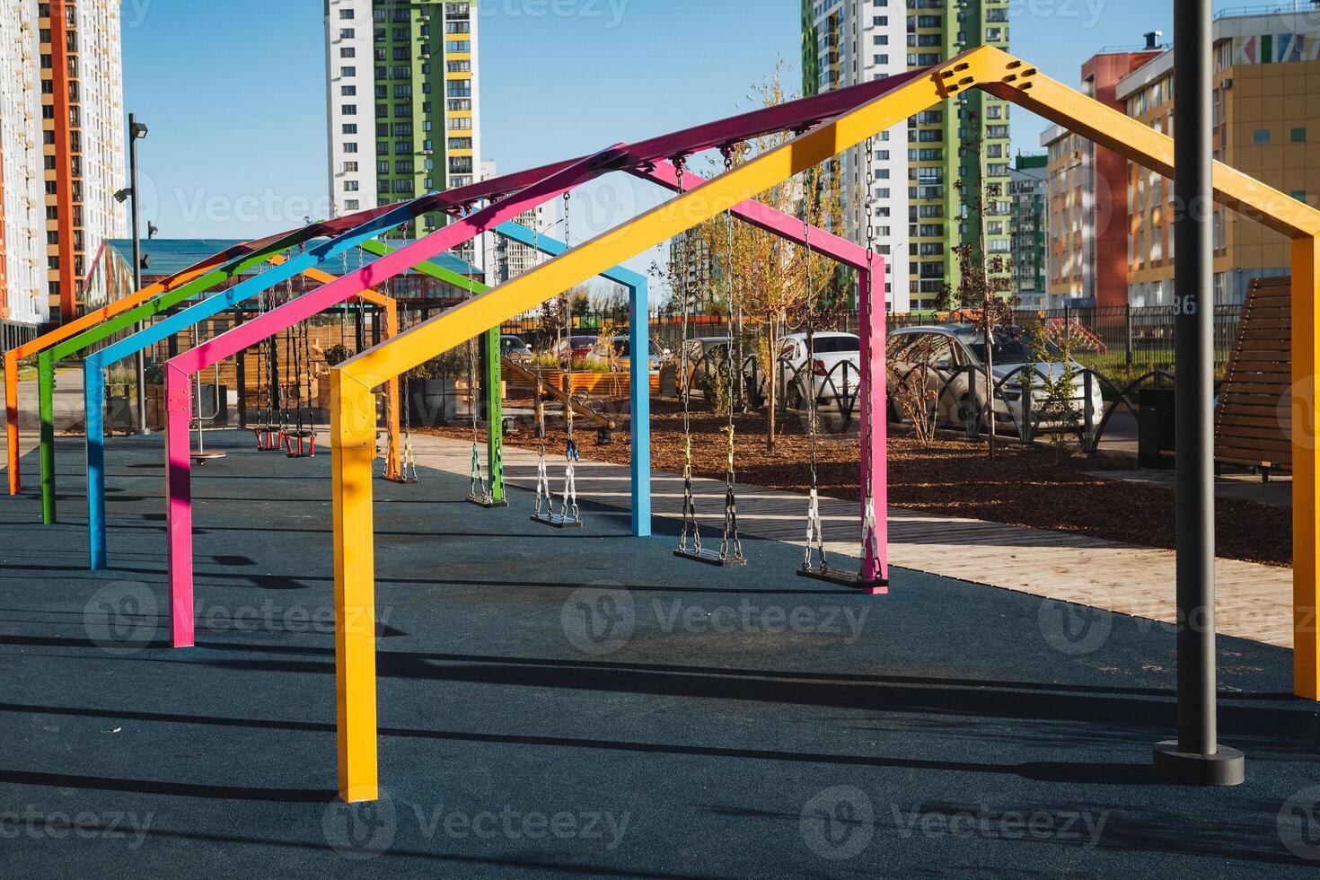 In a vibrant, bustling park, tall poles elegantly rise majestically amid modern buildings, creating a lively urban atmosphere that is perfect for leisure and recreation activities photo