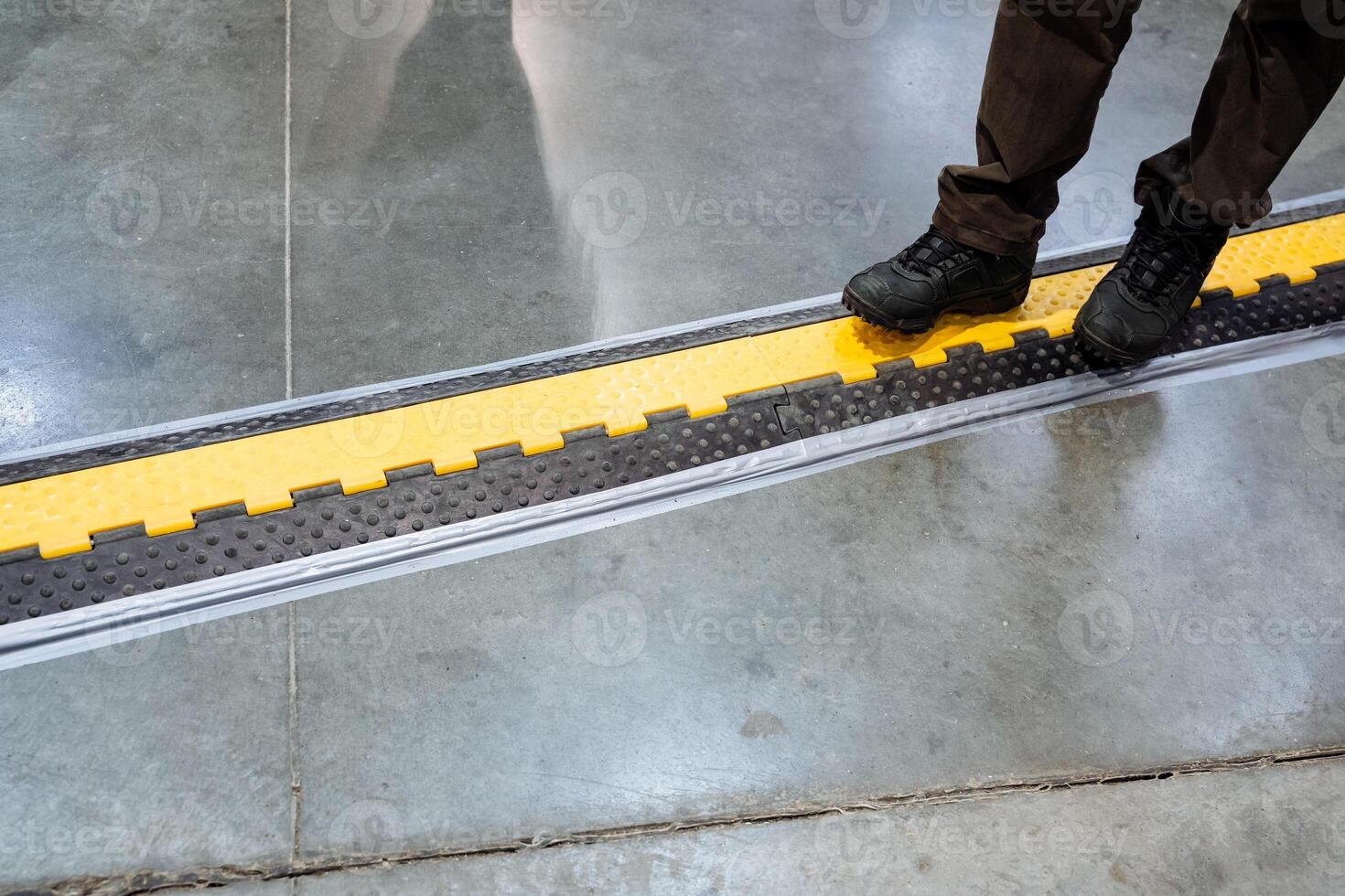 A person is standing on a staircase that features a bold and striking yellow and black pattern, which creates an exciting and vibrant visual contrast that truly captures attention photo