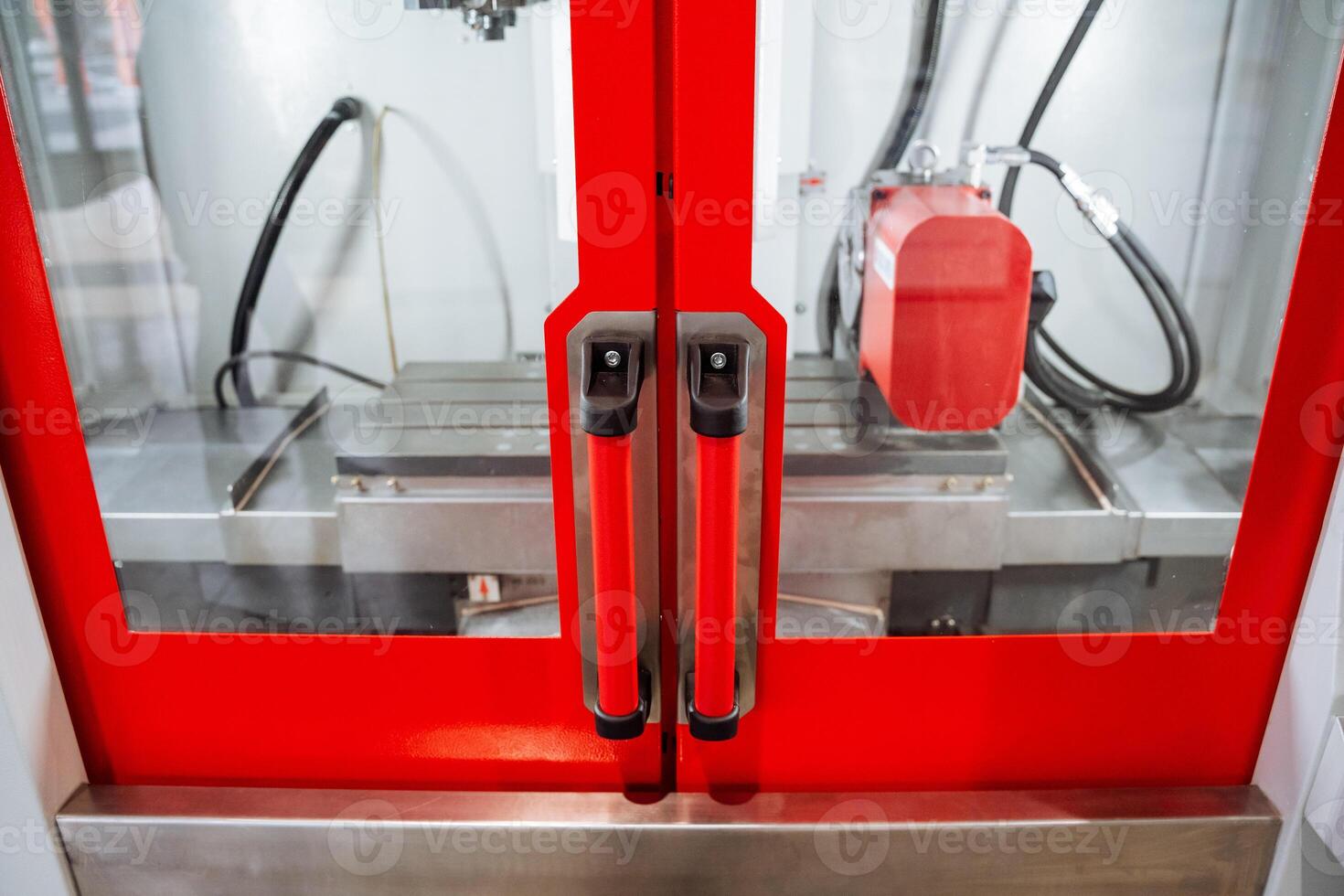 A vividly striking red door that intriguingly conceals within it a complex and intricate machine that is embedded, hinting at the fascinating mechanical workings behind its vibrant exterior photo