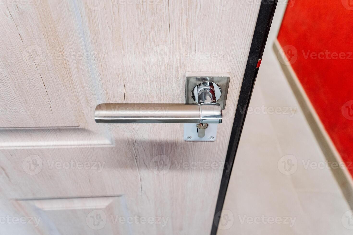 Silver handle of the front door to the house, top view of the handle of the holder, door to the apartment. photo