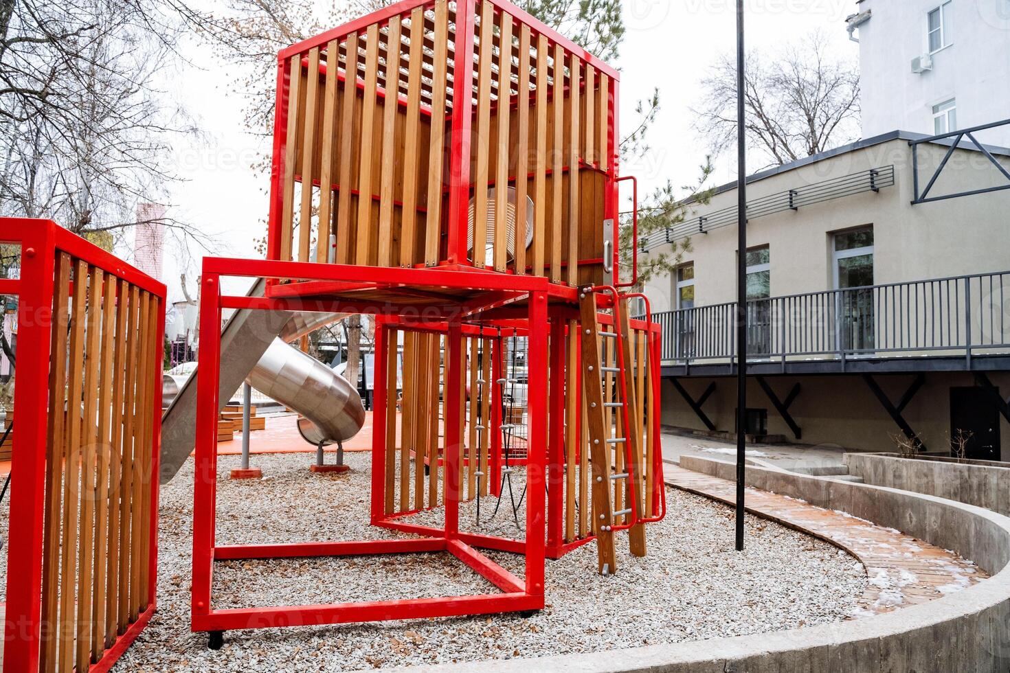 Nestled within a beautiful park, a charming wooden playground with an inviting slide and sturdy stairs offers a delightful space for children to play, engage, and explore the great outdoors photo