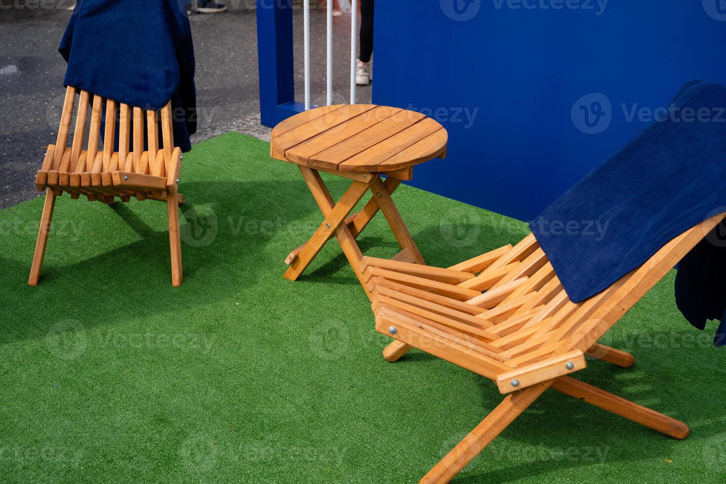 In a cozy setting with two wooden chairs, a sturdy table, and a green carpet, it creates a warm atmosphere ideal for relaxation and engaging conversations among friends or family photo