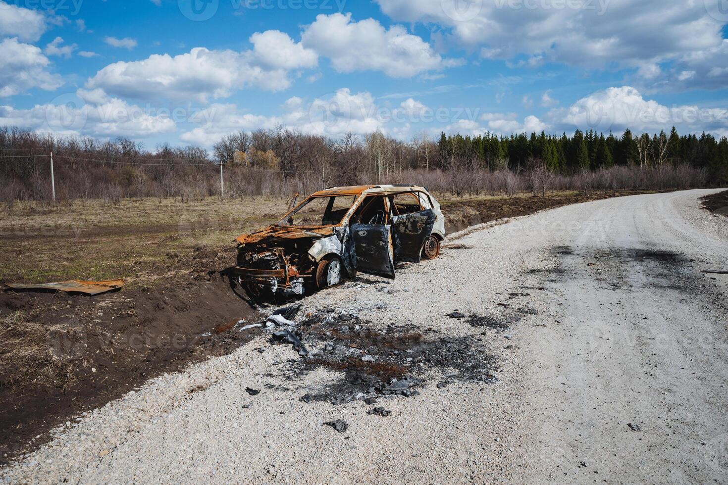 A car burned to the ground stands on the side of the road outside the city, an accident that killed the car in a fire. photo