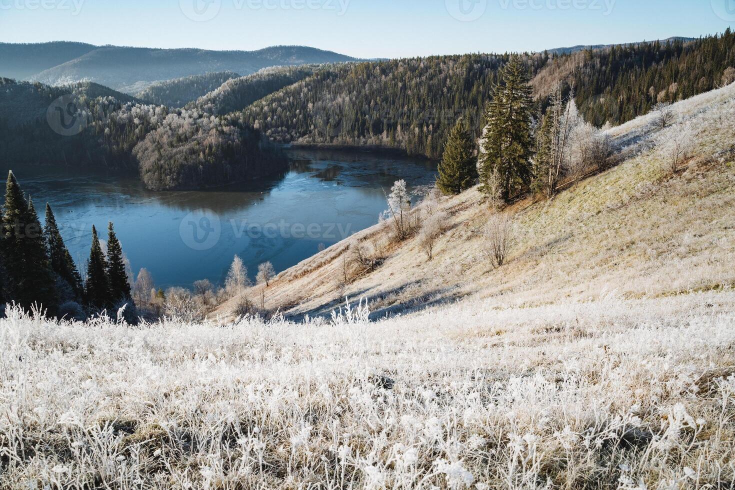 Mountain lake in the mountains, bird's eye view of the river, beautiful winter landscape, sunny morning, taiga forest, photo