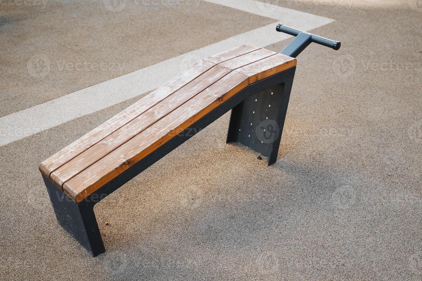 A sturdy wooden bench featuring a durable metal frame is sitting firmly on the ground, ready to provide seating for outdoor activities and gatherings in your backyard or park space photo