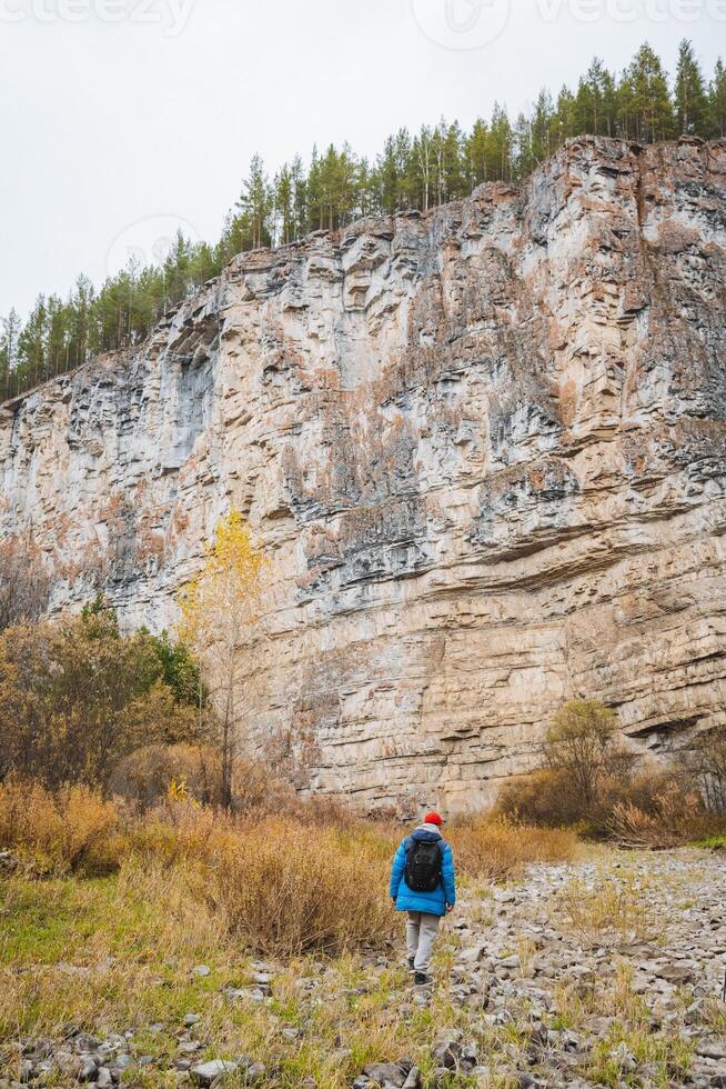 A child embarks on an exhilarating adventure in a breathtaking, rocky landscape filled with vibrant autumn colors and natural beauty photo