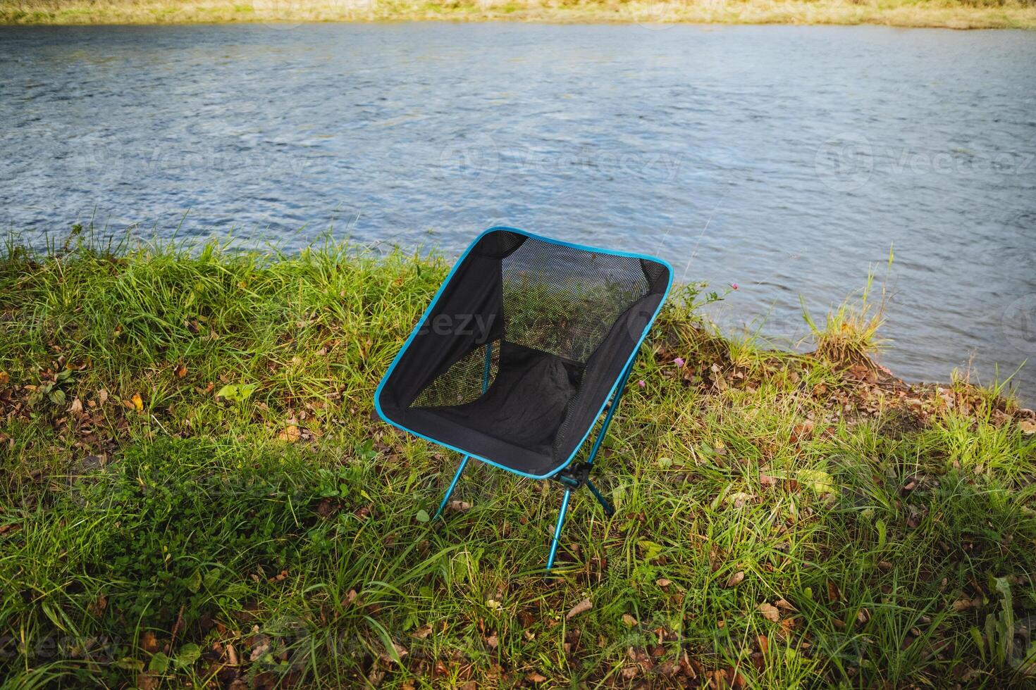 Experience the ultimate in comfort and relaxation with a Riverside Portable Camping Chair, which is ideal for enjoying the outdoors amidst nature photo