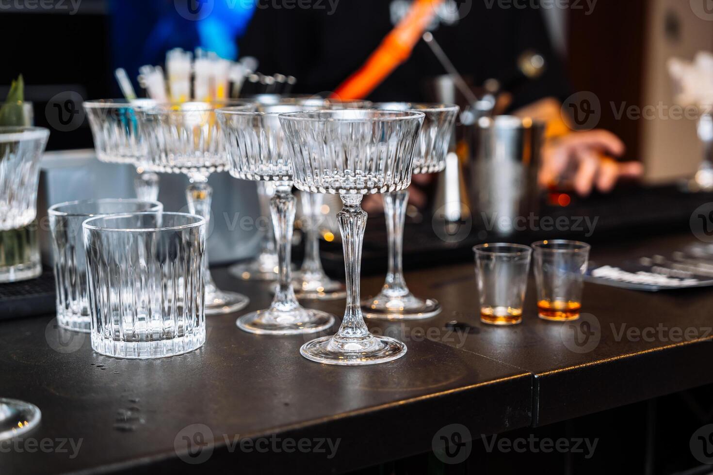 Enjoying alcohol tasting and cocktail preparation at a vibrant bar photo