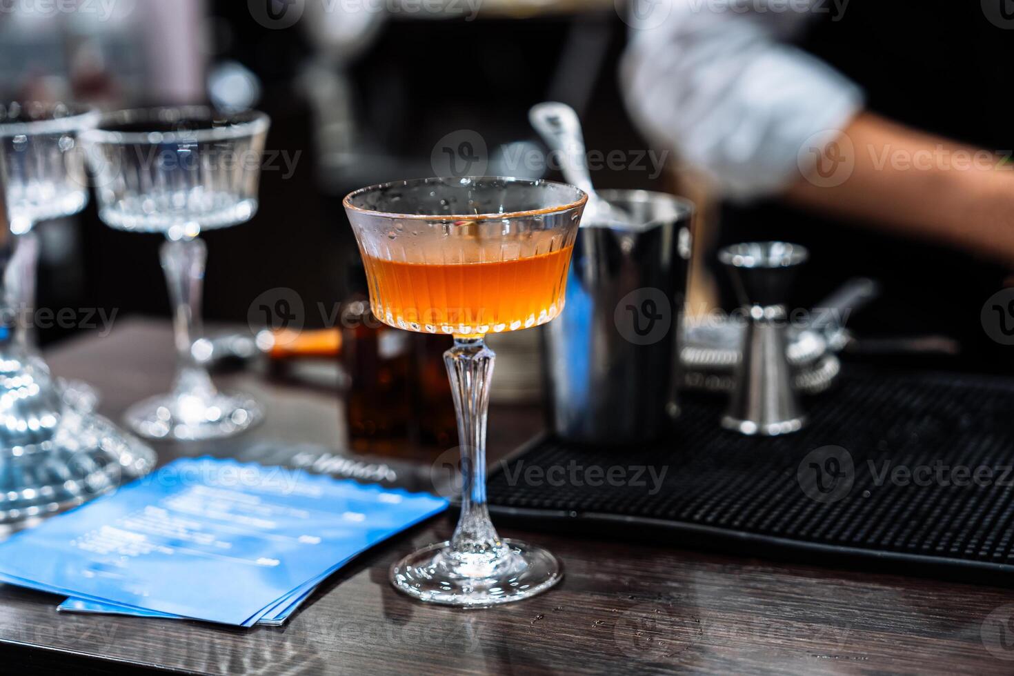 Cocktail preparation and tasting at a vibrant mixology event in the evening photo