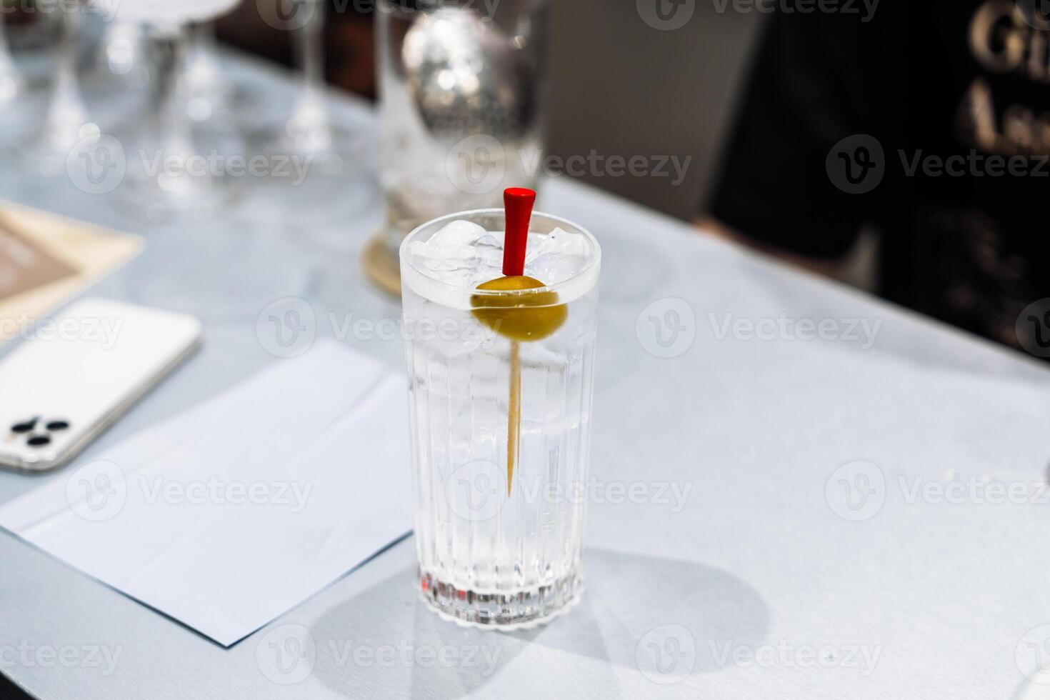 Tasting cocktails and preparing drinks at a bustling bar in the evening photo