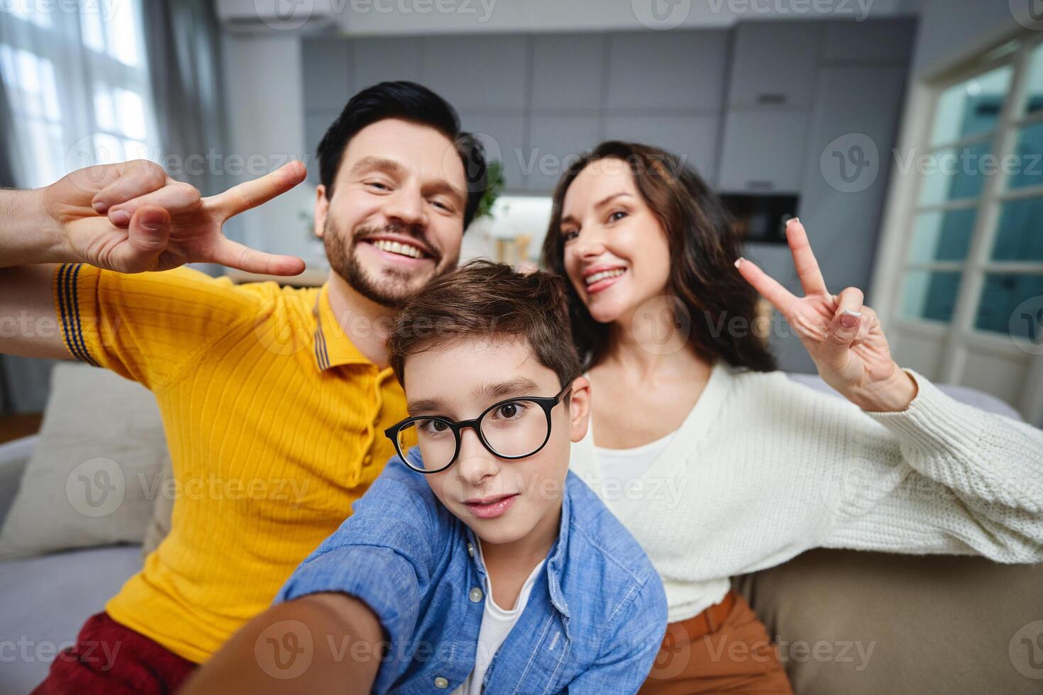 Family enjoys time together at home taking a cheerful selfie indoors photo