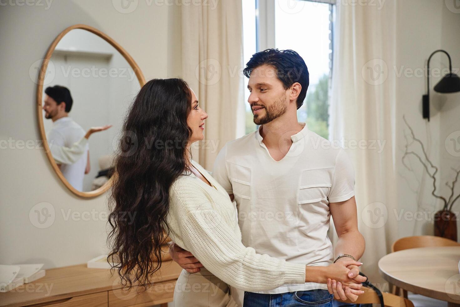 Couple smiling and enjoying a cozy moment in a modern living room photo