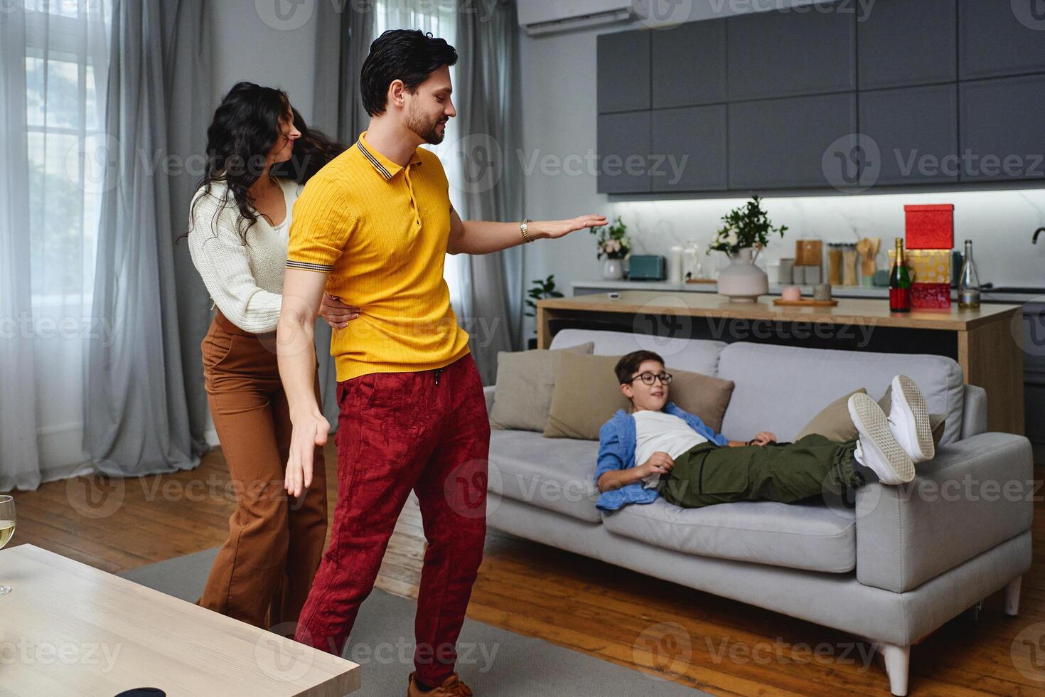 Family enjoying a playful moment in a cozy living room in the afternoon photo