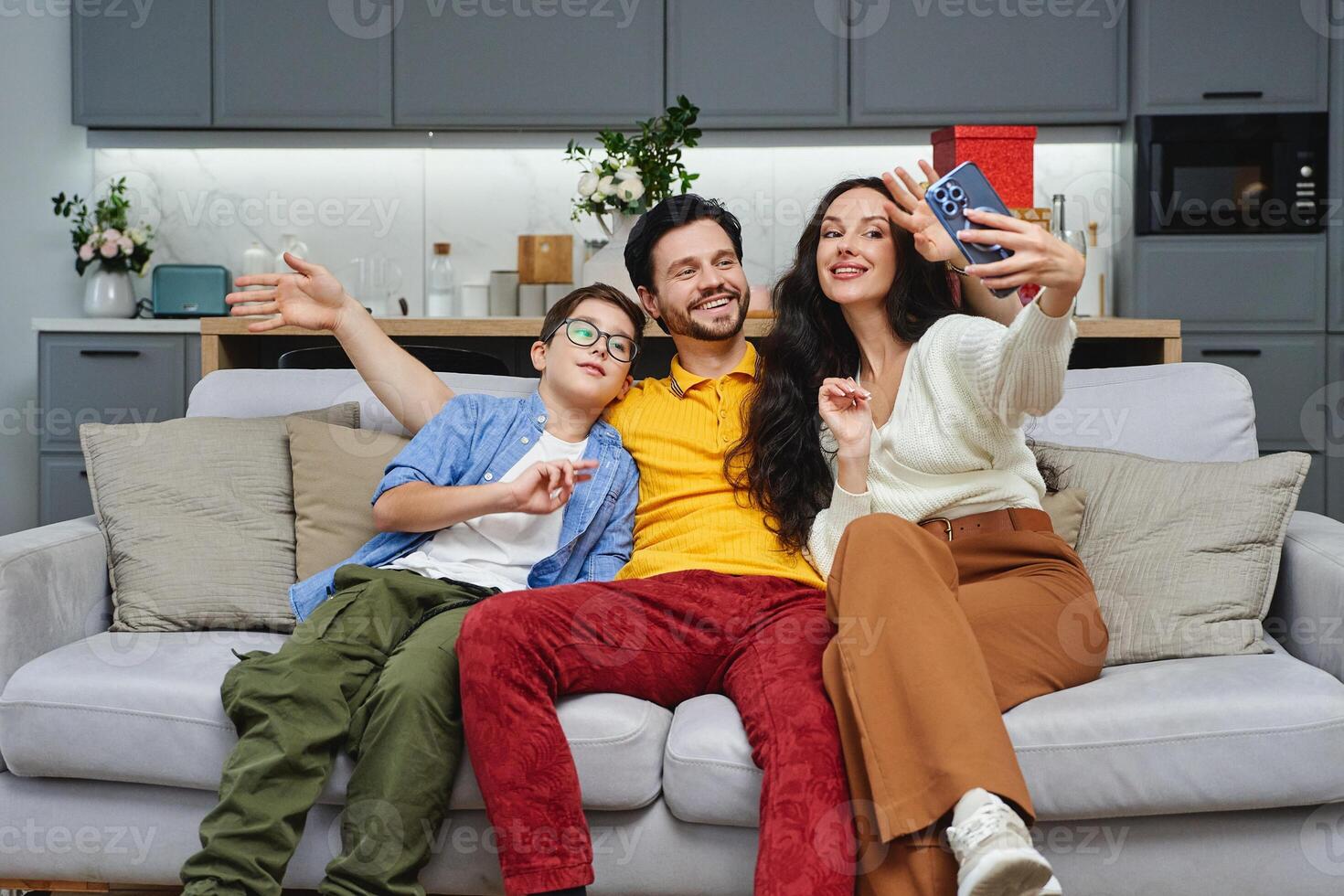 Family enjoying a fun moment together while taking a selfie indoors photo