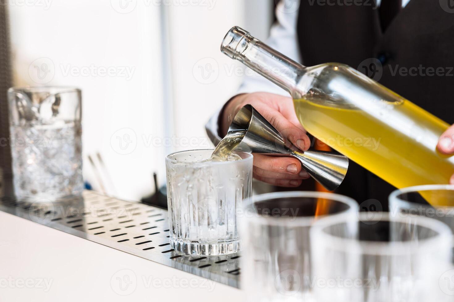 Cocktail preparation at a stylish bar during an evening tasting event photo