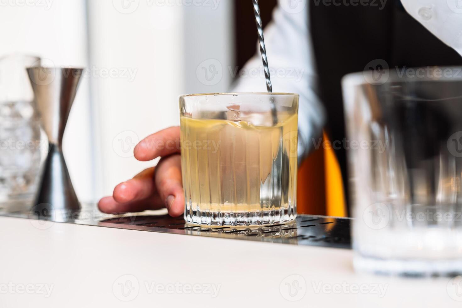 Crafting a refreshing cocktail during an evening gathering at a bar photo