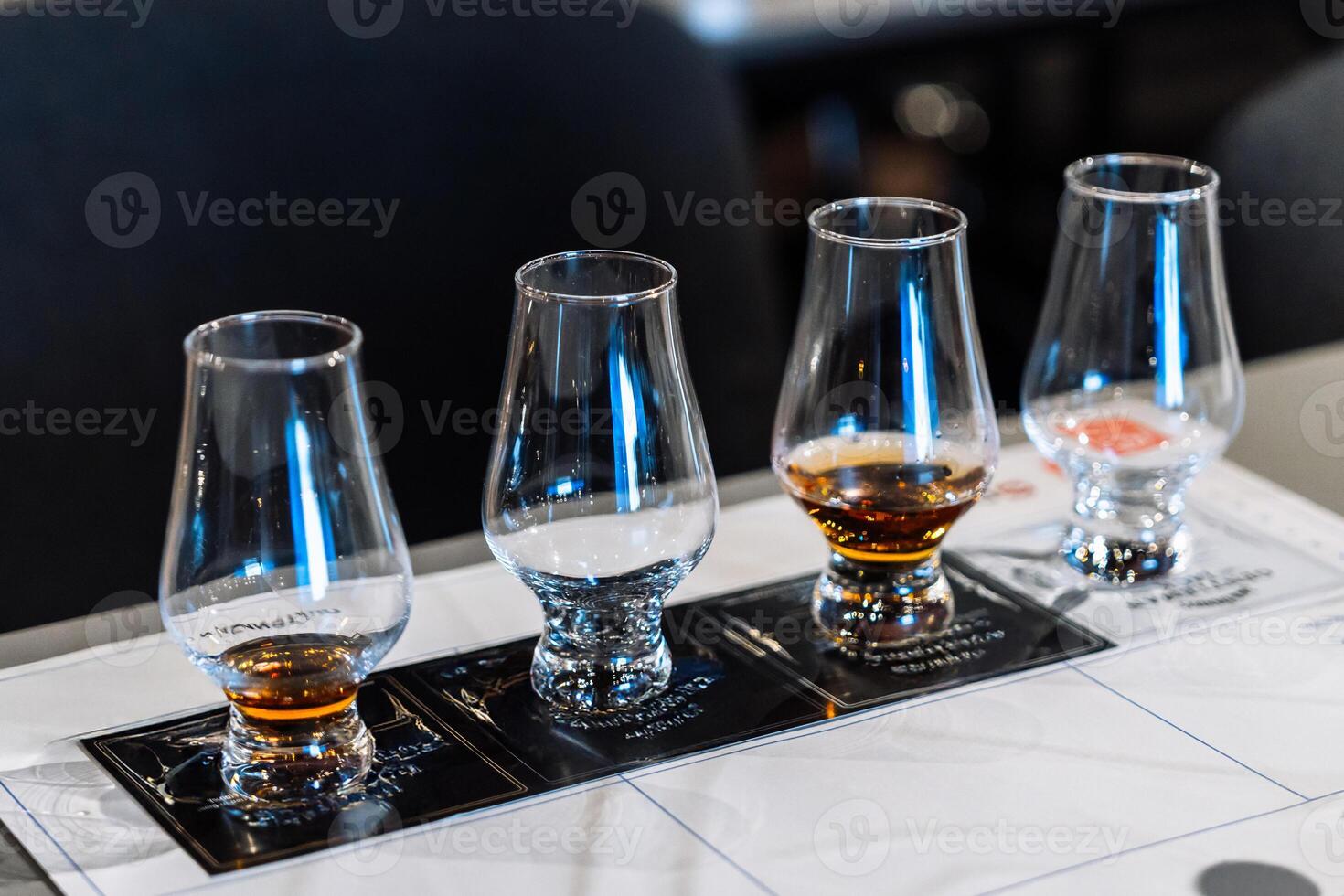 Tasting session with whiskey samples and cocktail preparations at a bar photo