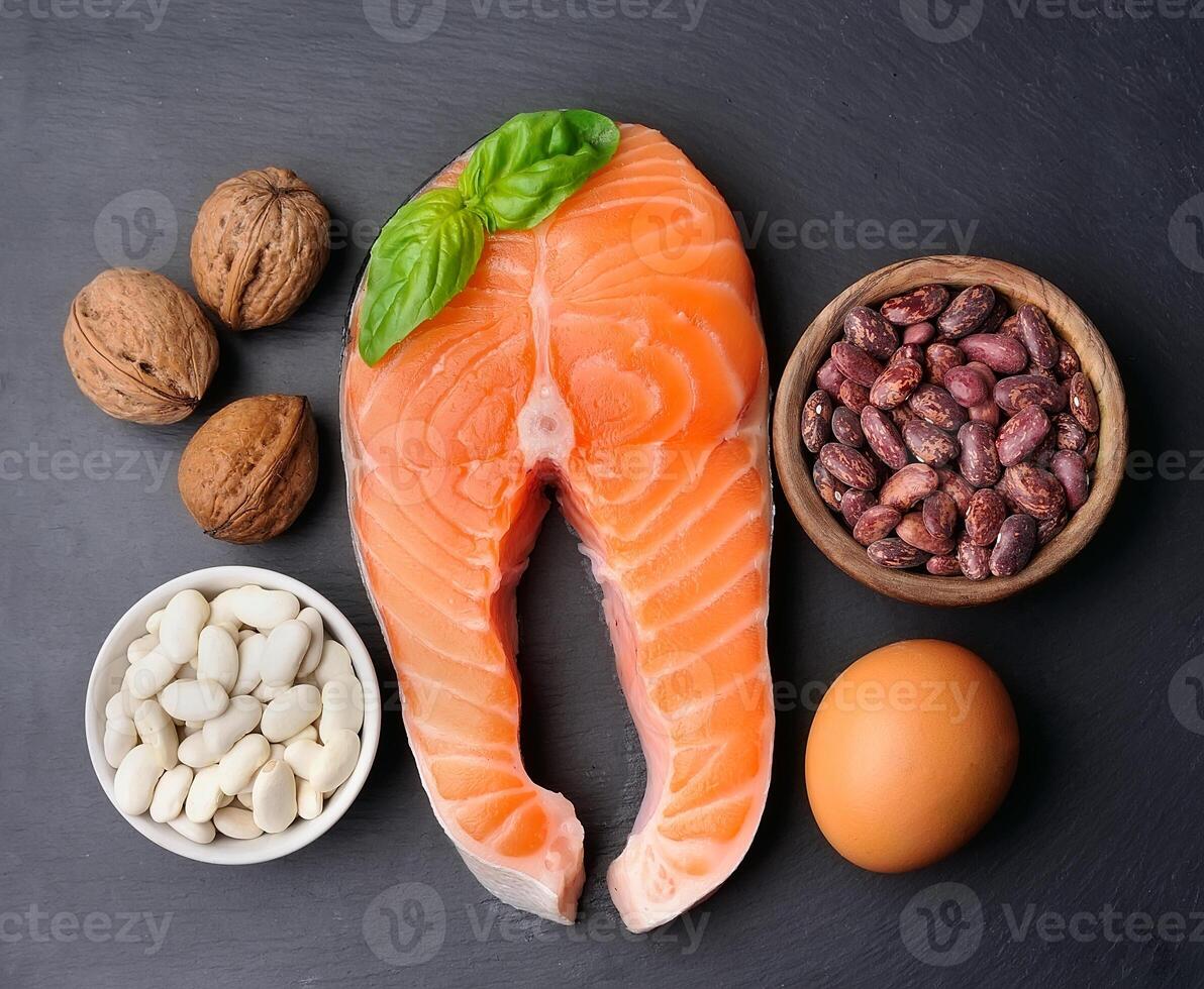 Healthy food. Crude steak of salmon and walnuts , egg top view on black backgrounds photo