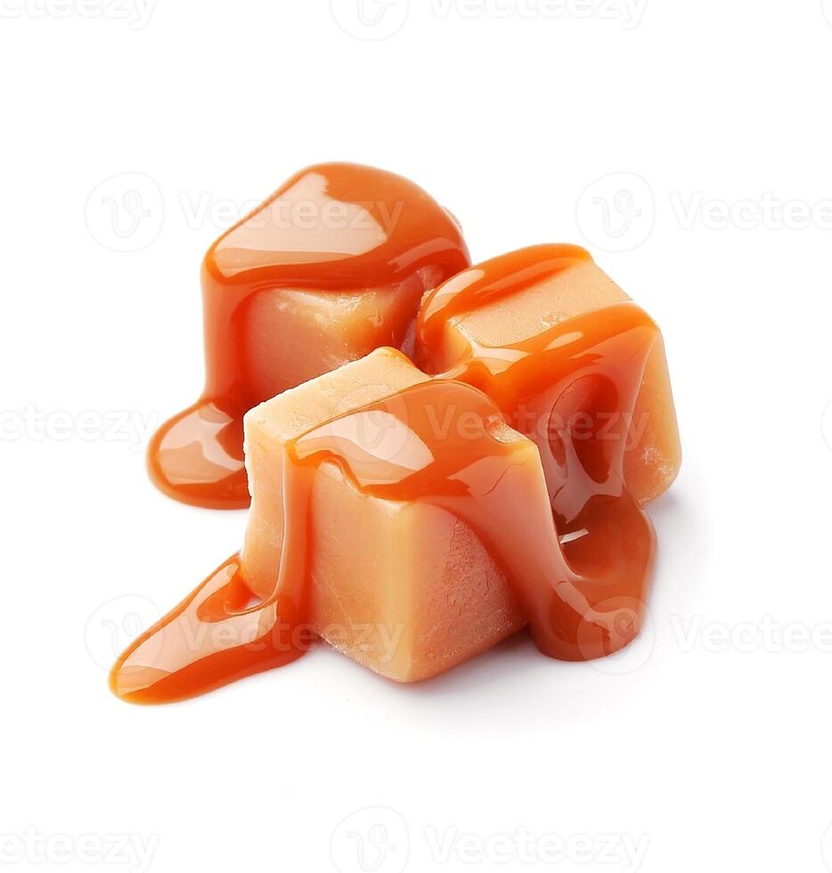 Caramel candies with caramel topping on white backgrounds. Healthy food dessert on white. Toffee candy. photo