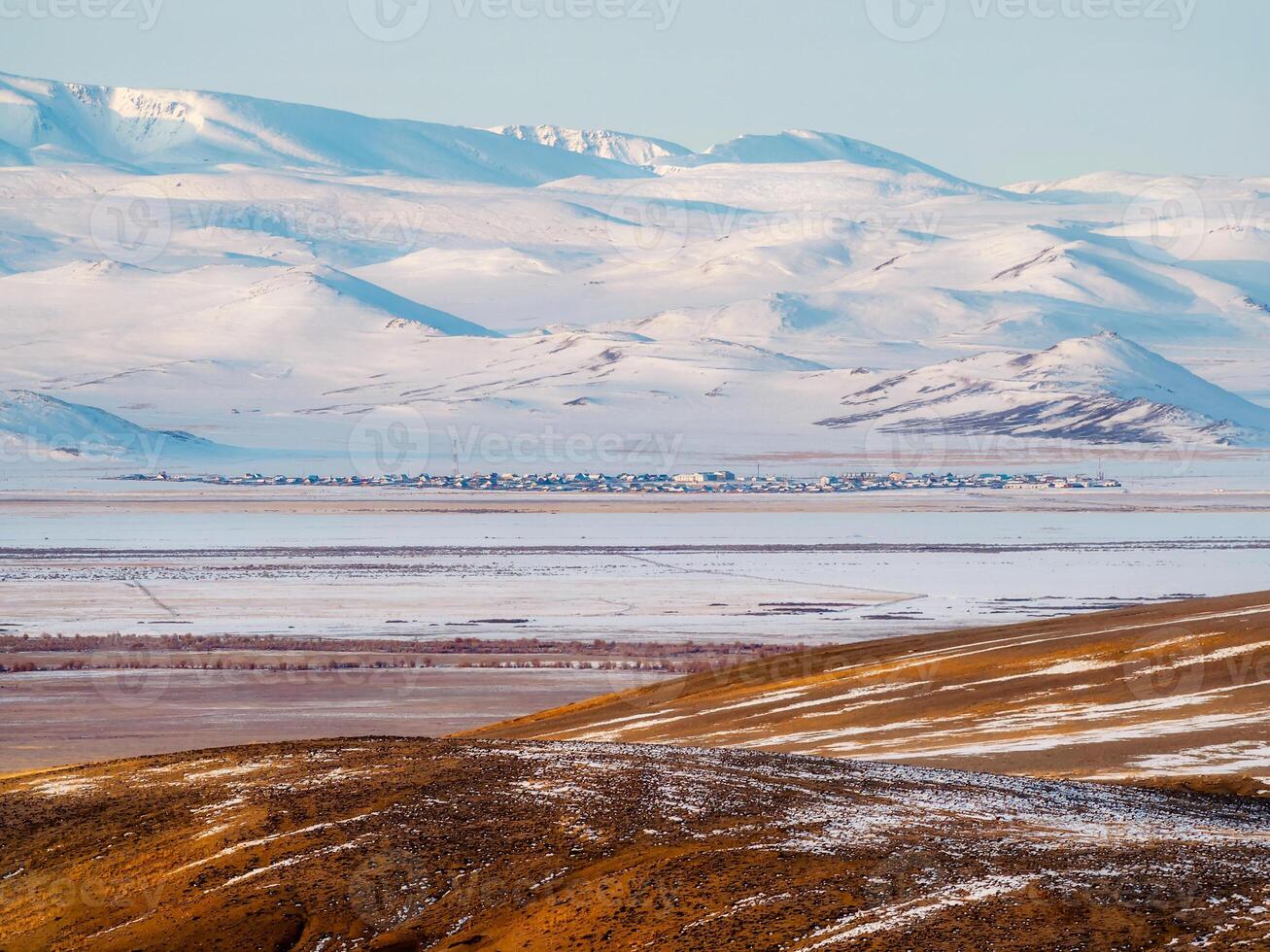 Authentic small town in the distance is covered with snow in the photo