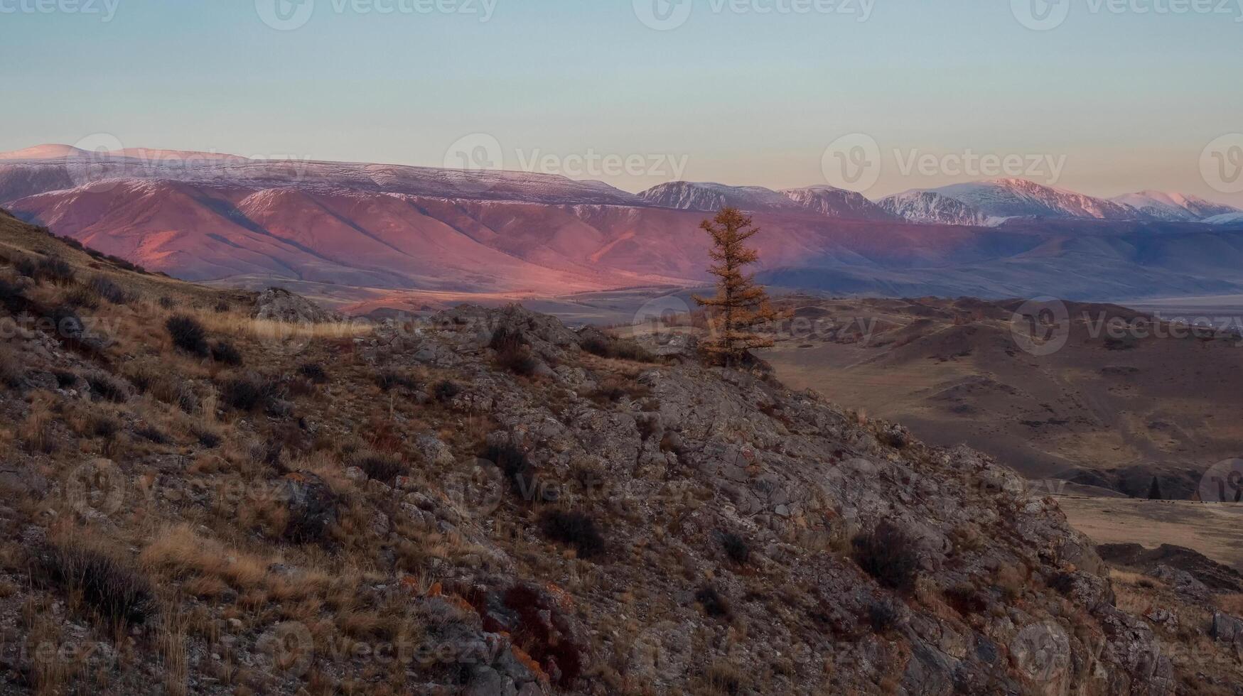 High snowy mountains in last light with desert hills photo
