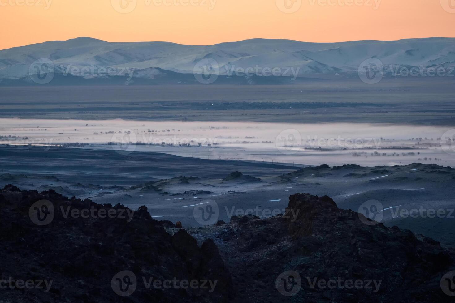 Highland river valley with morning fog on a background of snow covered mountains and glaciers with beautiful sunrise. in the steppe near the mountains during the autumn. Altai region. photo