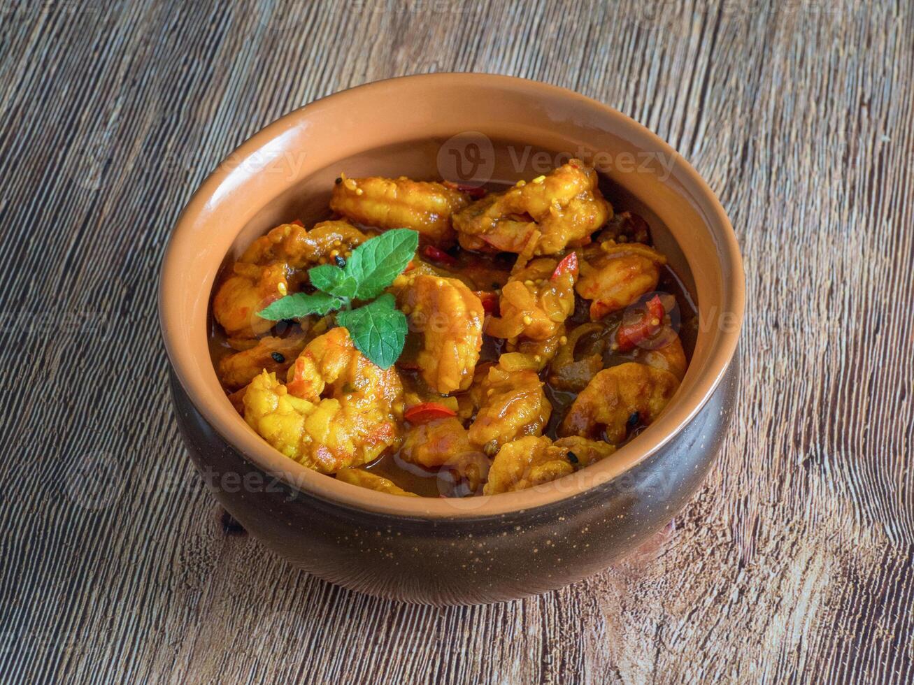 King Prawn Masala in a clay bowl. Traditional Indian cuisine photo