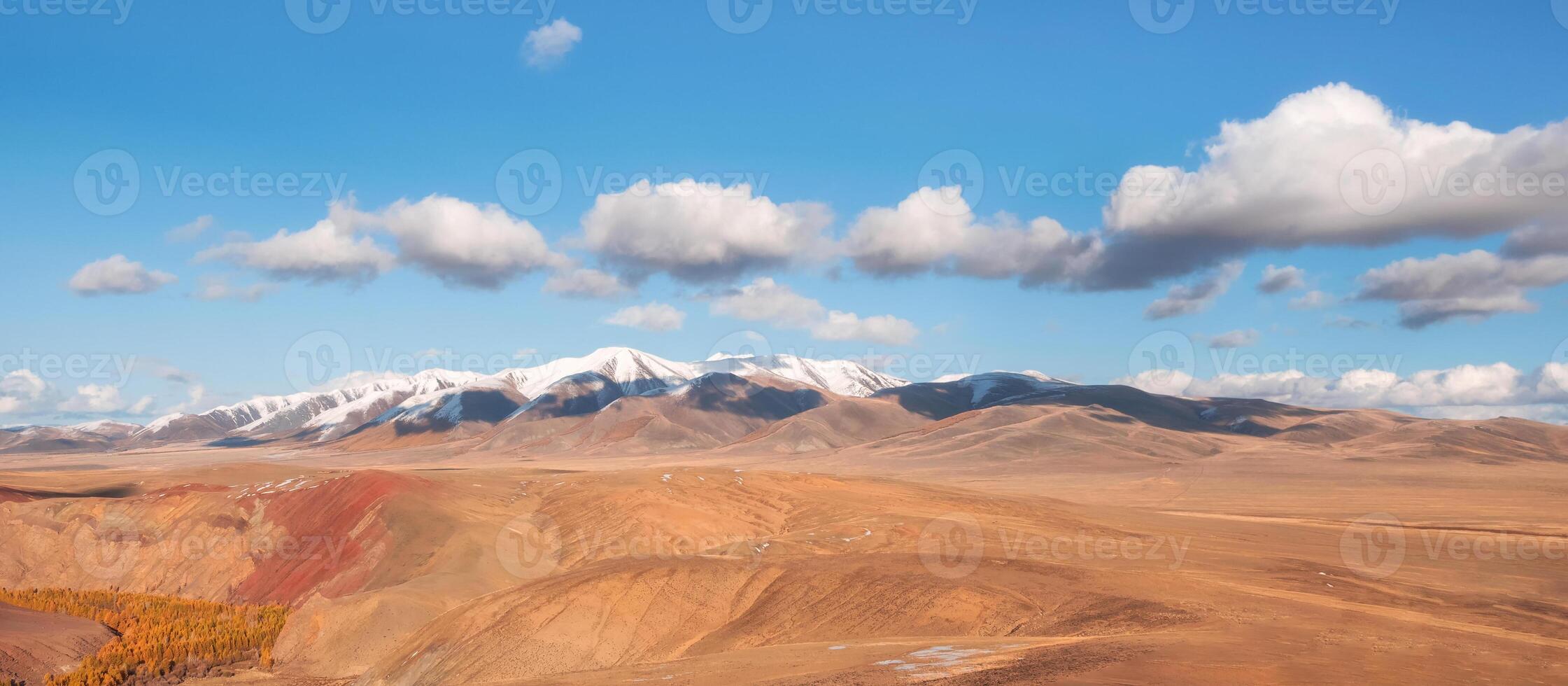Wide panoramic mountain landscape with golden autumn steppe photo