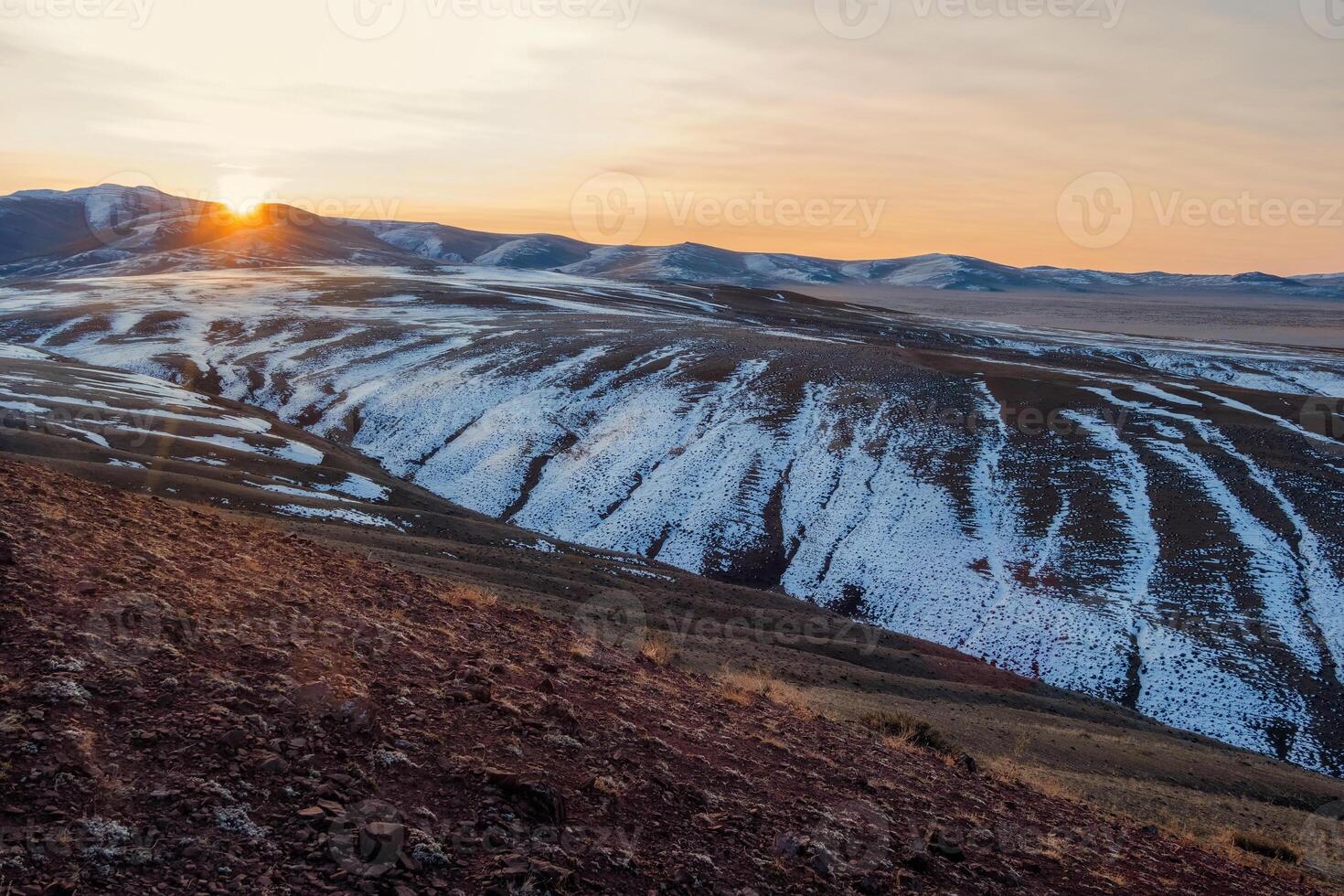 Amazing sunset over the autumn snow-capped mountains in the Kokorya tract in the Altai Republic, such wanderlust. Mountain ice peaks of Siberia and sunny sky of Altai background. photo