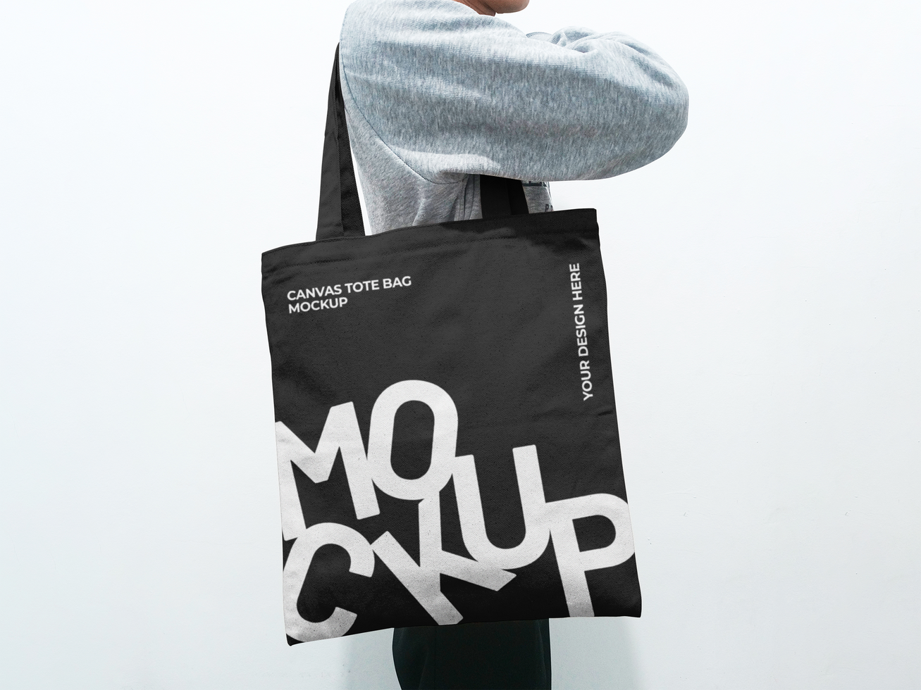 Man Holding a Tote Bag Mockup Side View psd