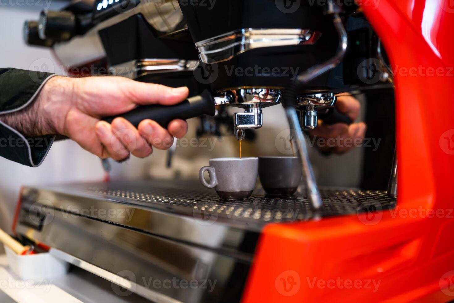 Close up of professional barista using coffee espresso machine. photo