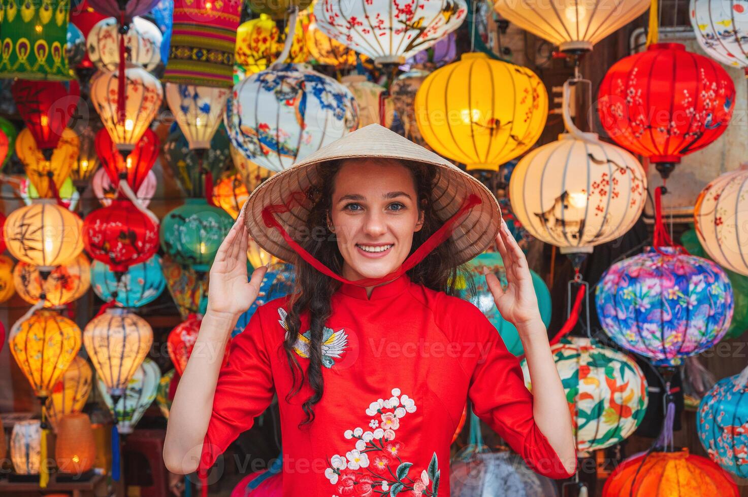 woman wearing Vietnamese dress with colorful lanterns, traveler sightseeing at Hoi An ancient town in central Vietnam photo