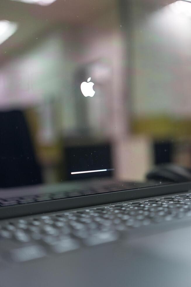 BANGKOK, THAILAND - DECEMBER 16, 2024 Installing Software update left sign on black screen of Apple macBook Pro laptop computer photo