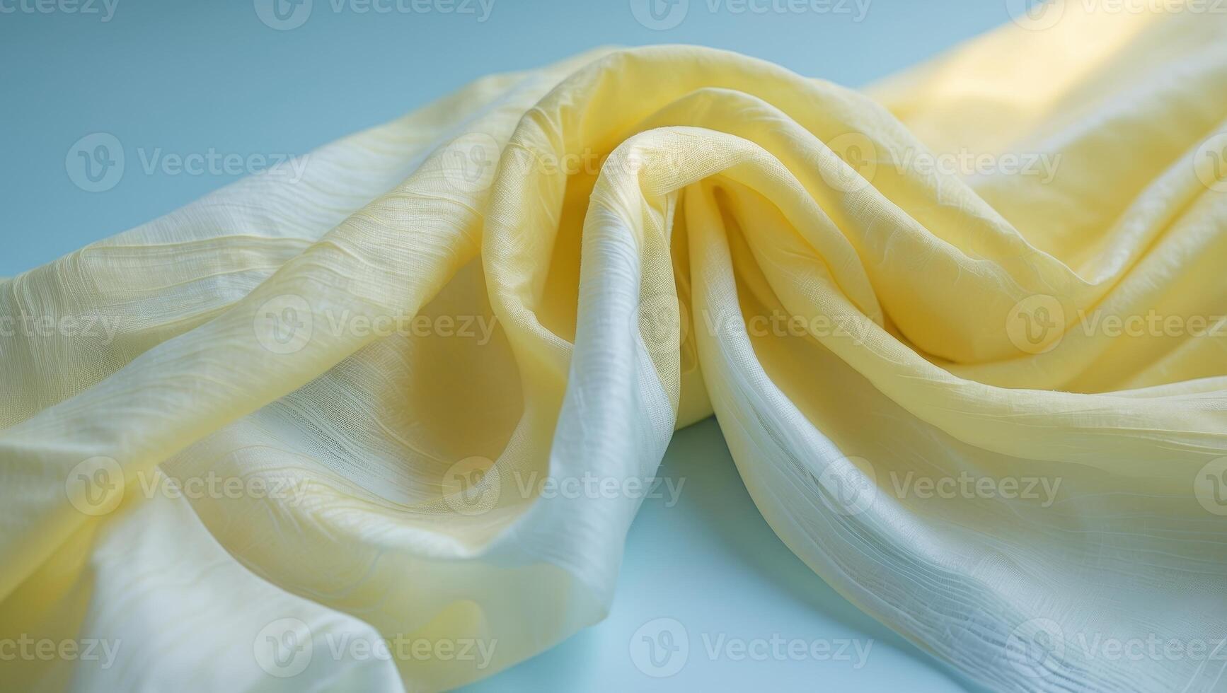A yellow silk fabric on a blue background. photo