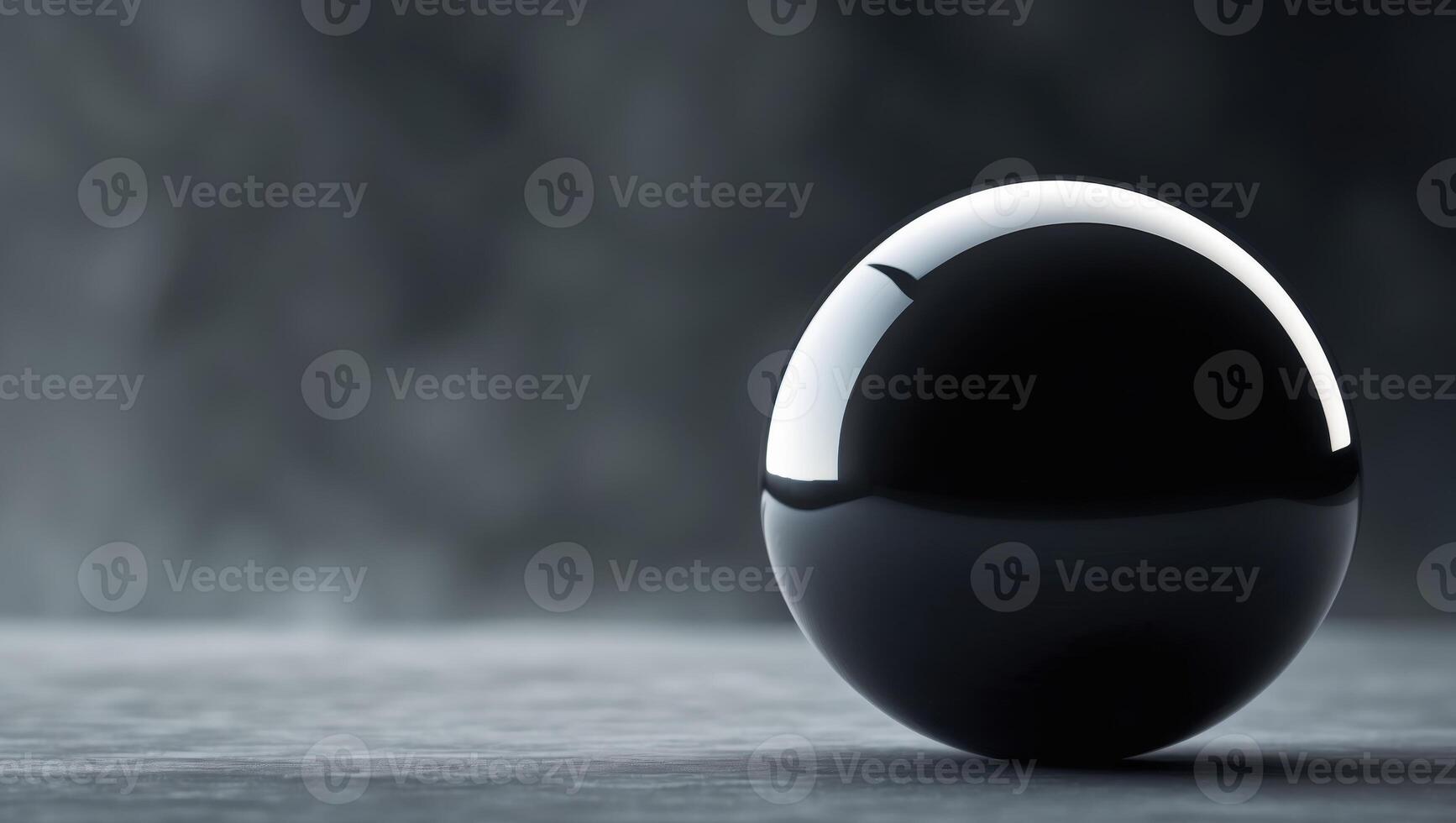 Large black sphere is in the middle of a dark background.Large black sphere is in the middle of a dark background. photo
