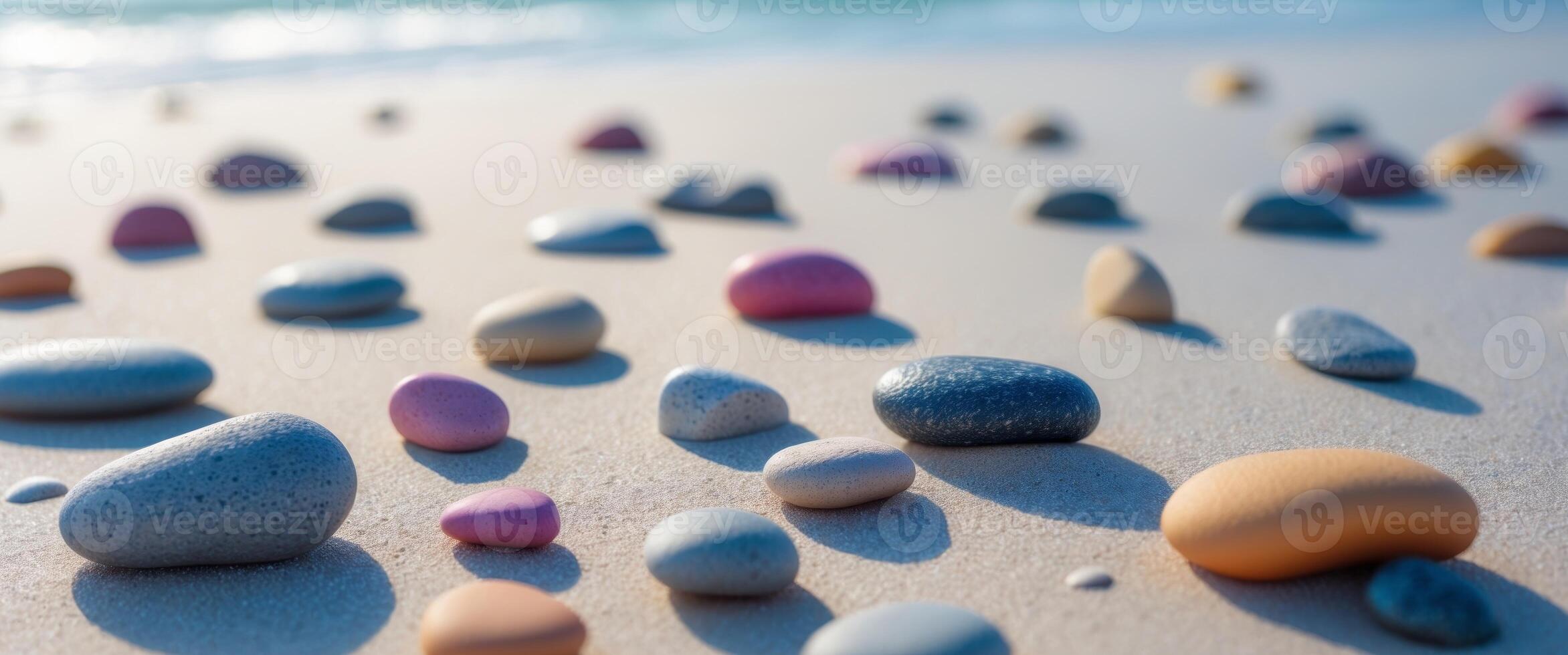 Array of colorful pebbles on sandy beach surface photo
