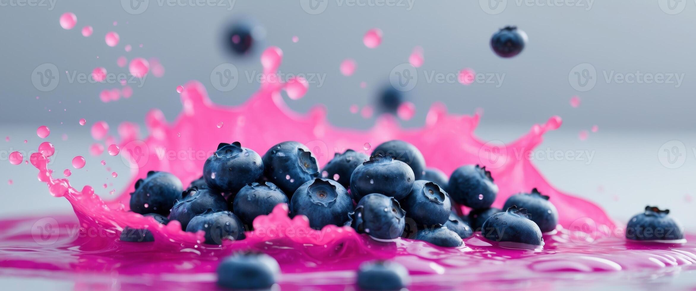 Fresh Blueberries Splashing in Vibrant Pink Liquid Action Shot photo
