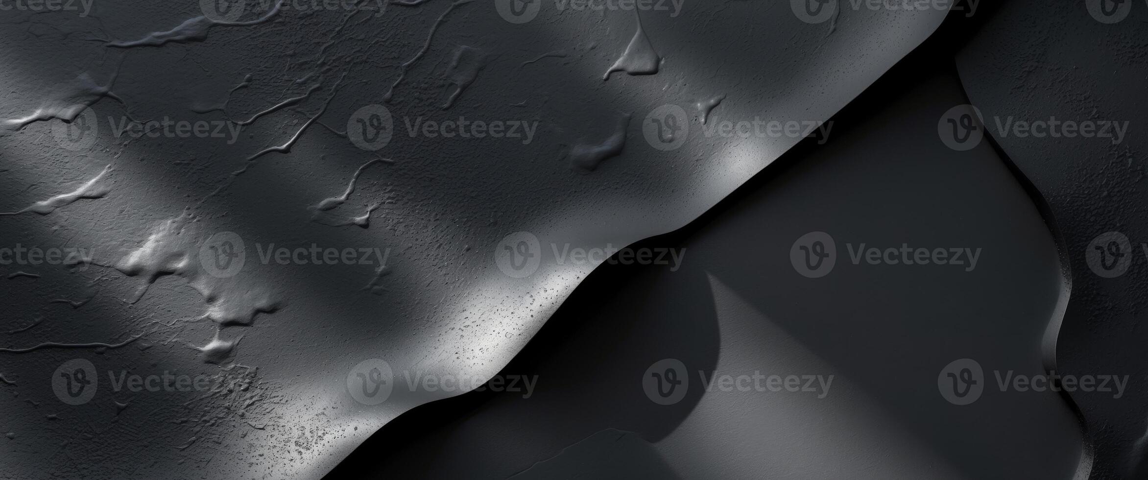 Textured black surface with subtle variations in light and shadowTextured black surface with subtle variations in light and shadow. photo