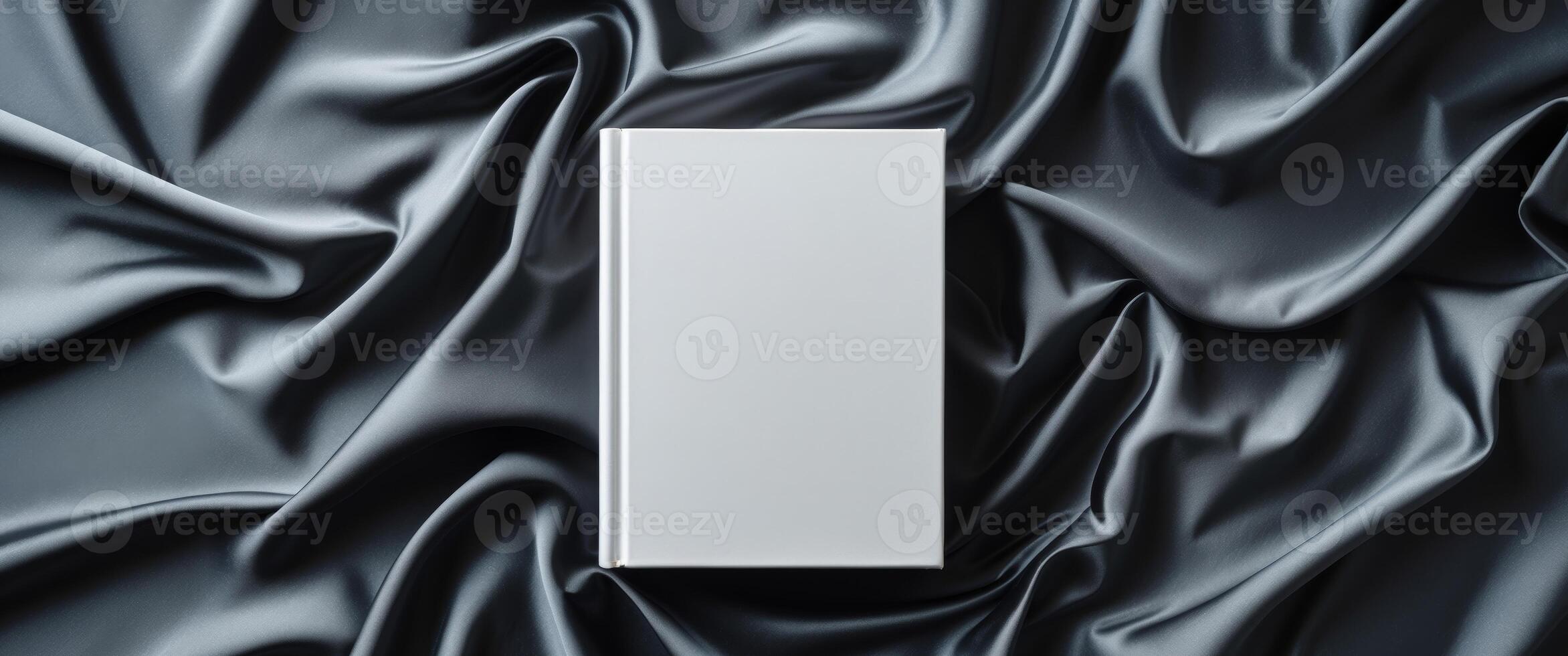 An empty white box on a dark fabric photo