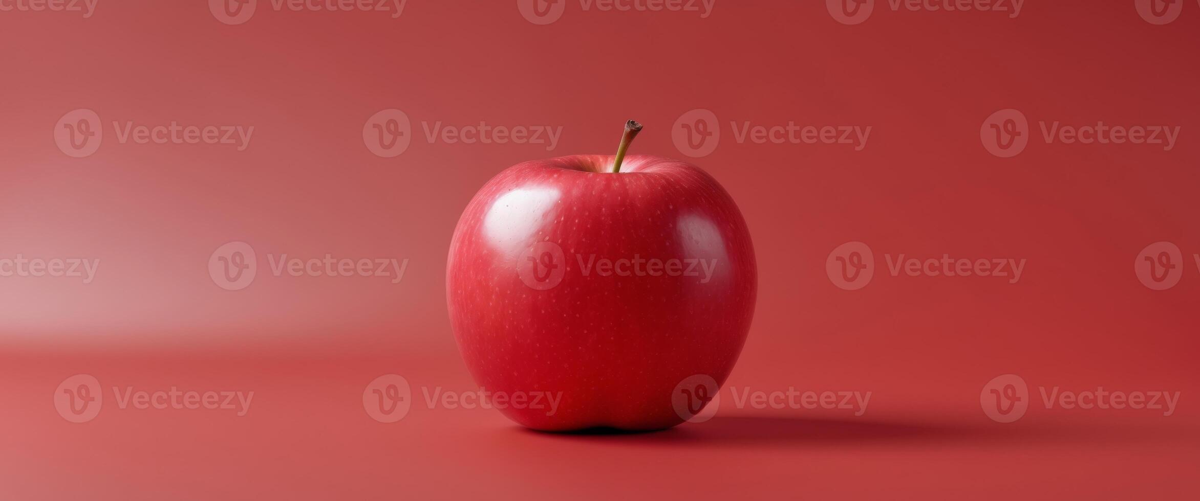Vibrant red apple on matching background for freshness and simplicityVibrant red apple on matching background for freshness and simplicity. photo