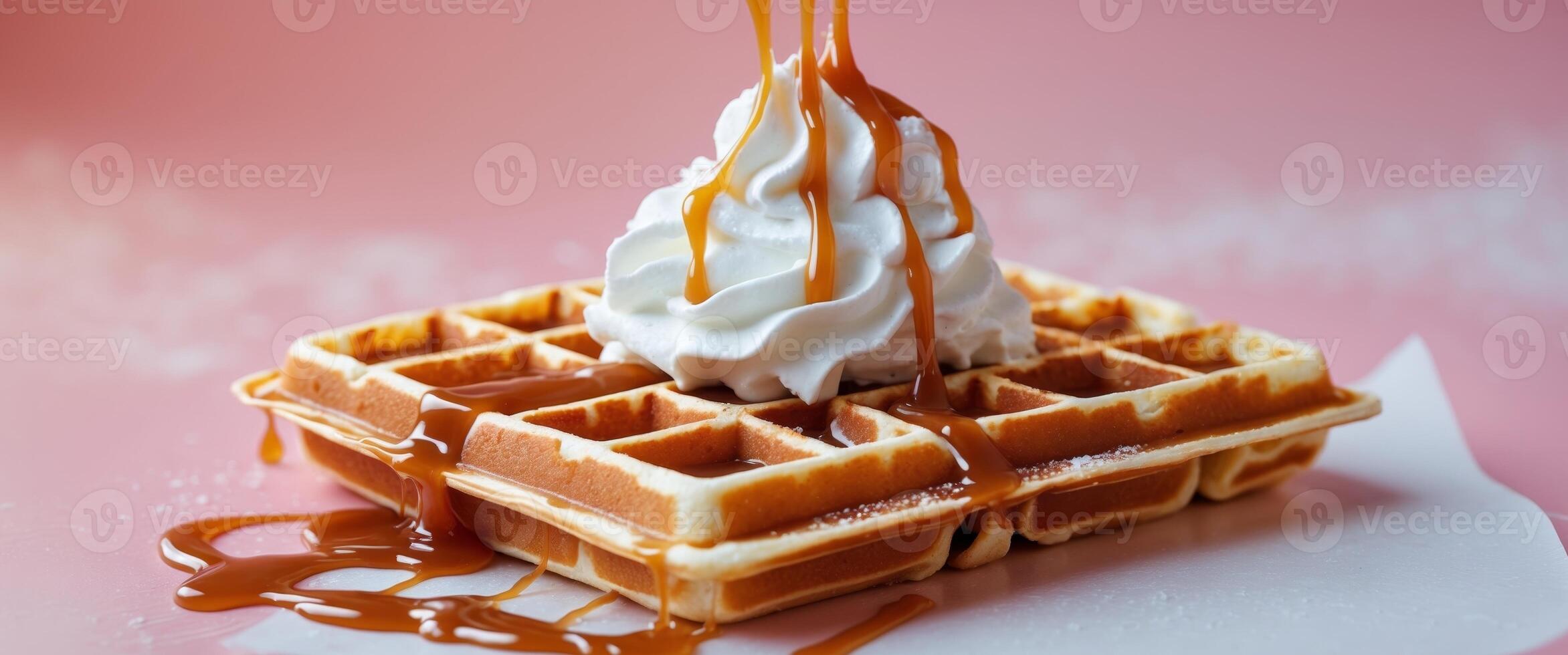 waffles with whipped cream and caramel on the pink backgroundwaffles with whipped cream and caramel on the pink background. photo