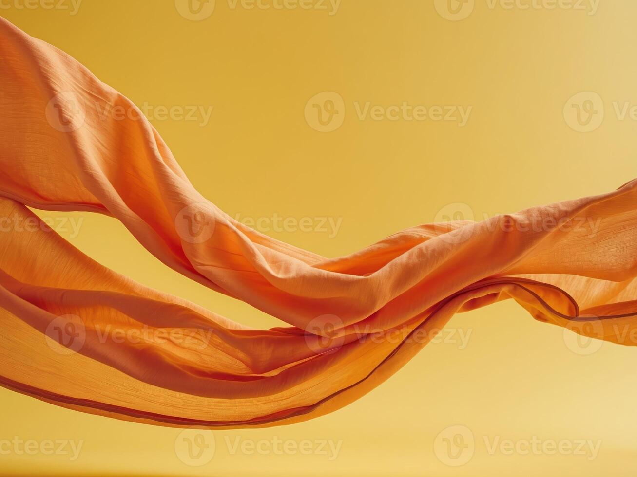 Flowing Orange Fabric on Bright Yellow Background Abstract Elegance in Motion photo