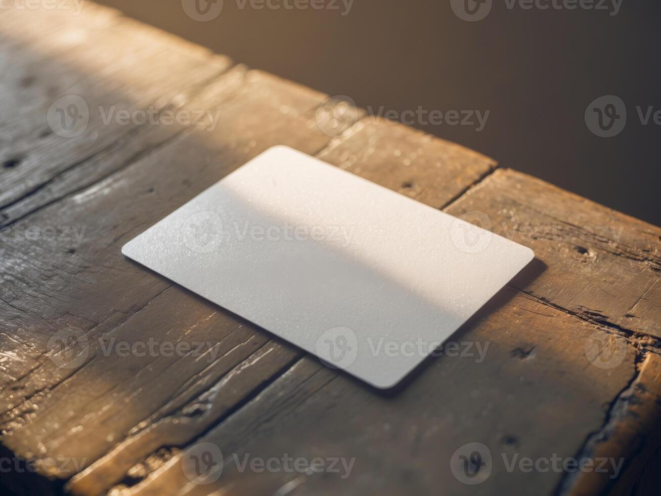 Blank card on wooden table with soft shadows photo