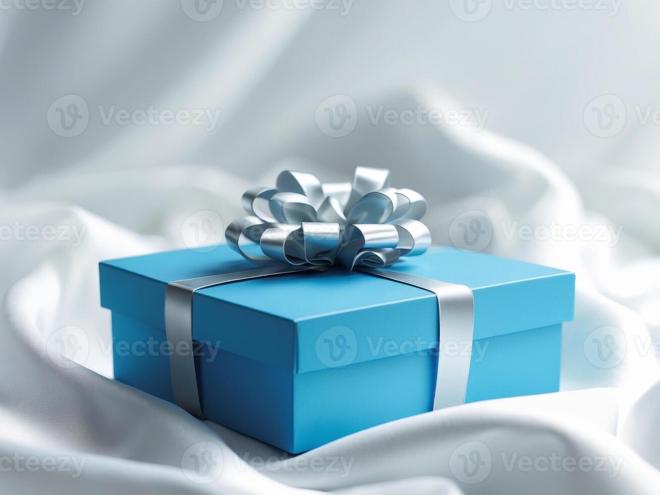 A blue box with a silver bow on top of it photo