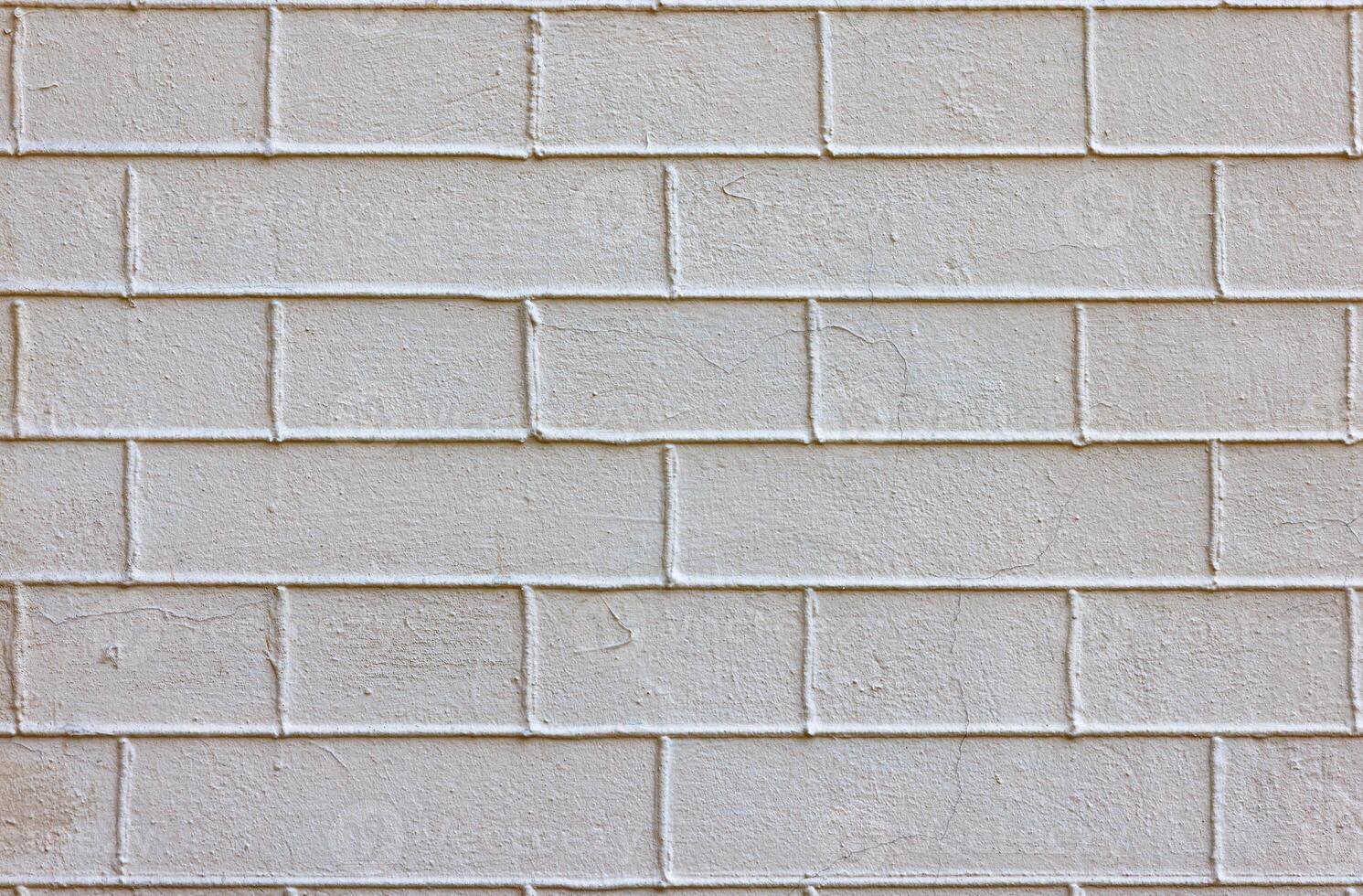 Texture of a plastered beige brick wall with exposed cement joints. photo