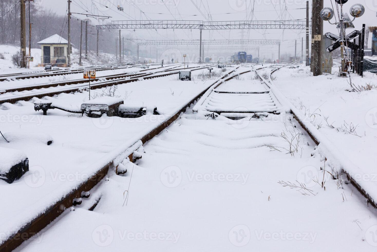 Snow covered paths at the railway station on a winter day. photo