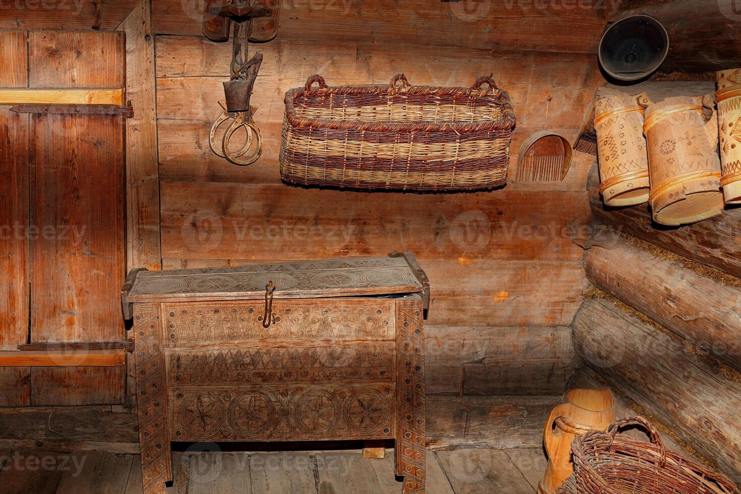 Entrance hall in an old rural hut with antique household utensils in penetrating rays of light and shadow lighting. photo