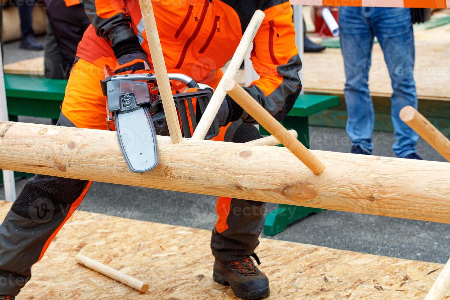 A fragment of the lumberjack competition, a demonstration of the technique of owning a chainsaw. photo