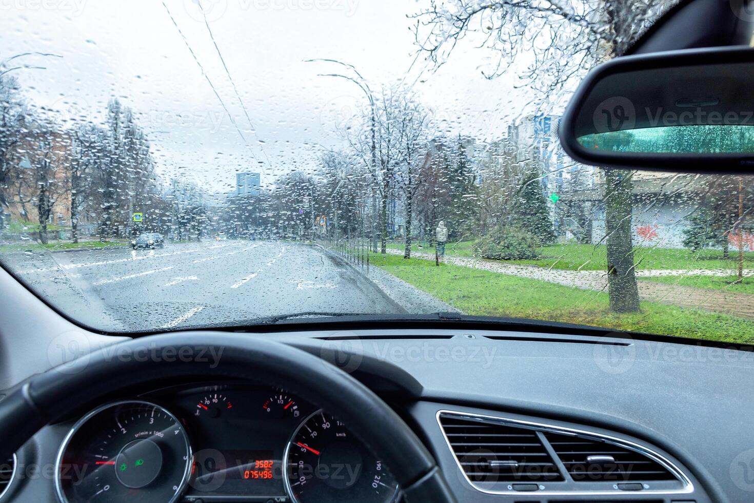 View from the car interior on rainy weather in early spring. photo